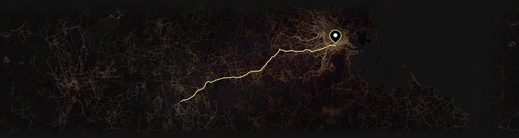 The Boston Marathon course traced as a glowing golden line across a dark map of greater Boston, from Hopkinton to the finish line in the city.