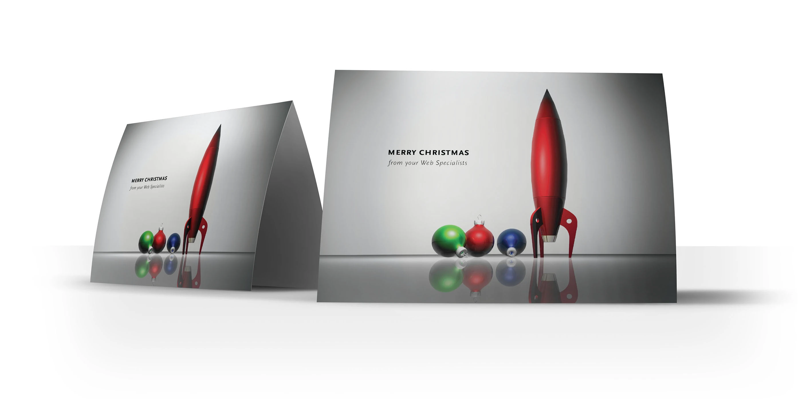 A Red Rocket holiday card — “Merry Christmas from your Web Specialists” — with the red rocket standing among Christmas ornaments.